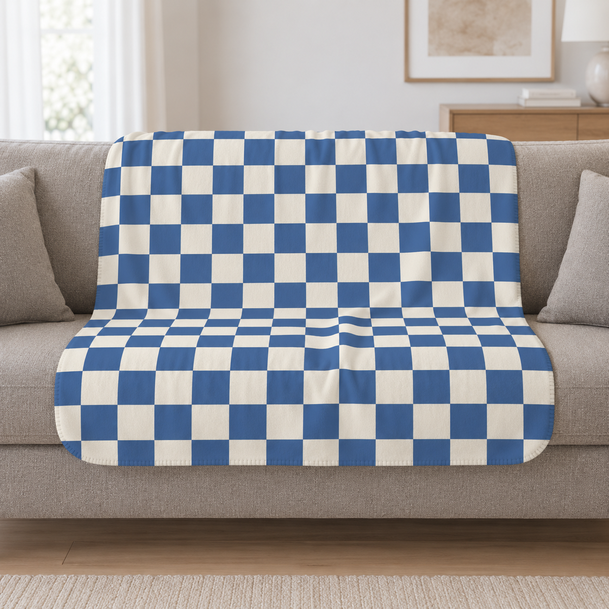 Blue Checkered Sherpa Blanket draped over a cream sofa in a living room