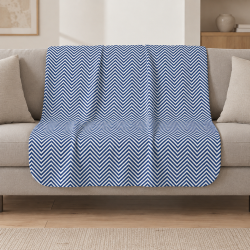 Blue Herringbone Sherpa Blanket draped over a cream sofa in a living room