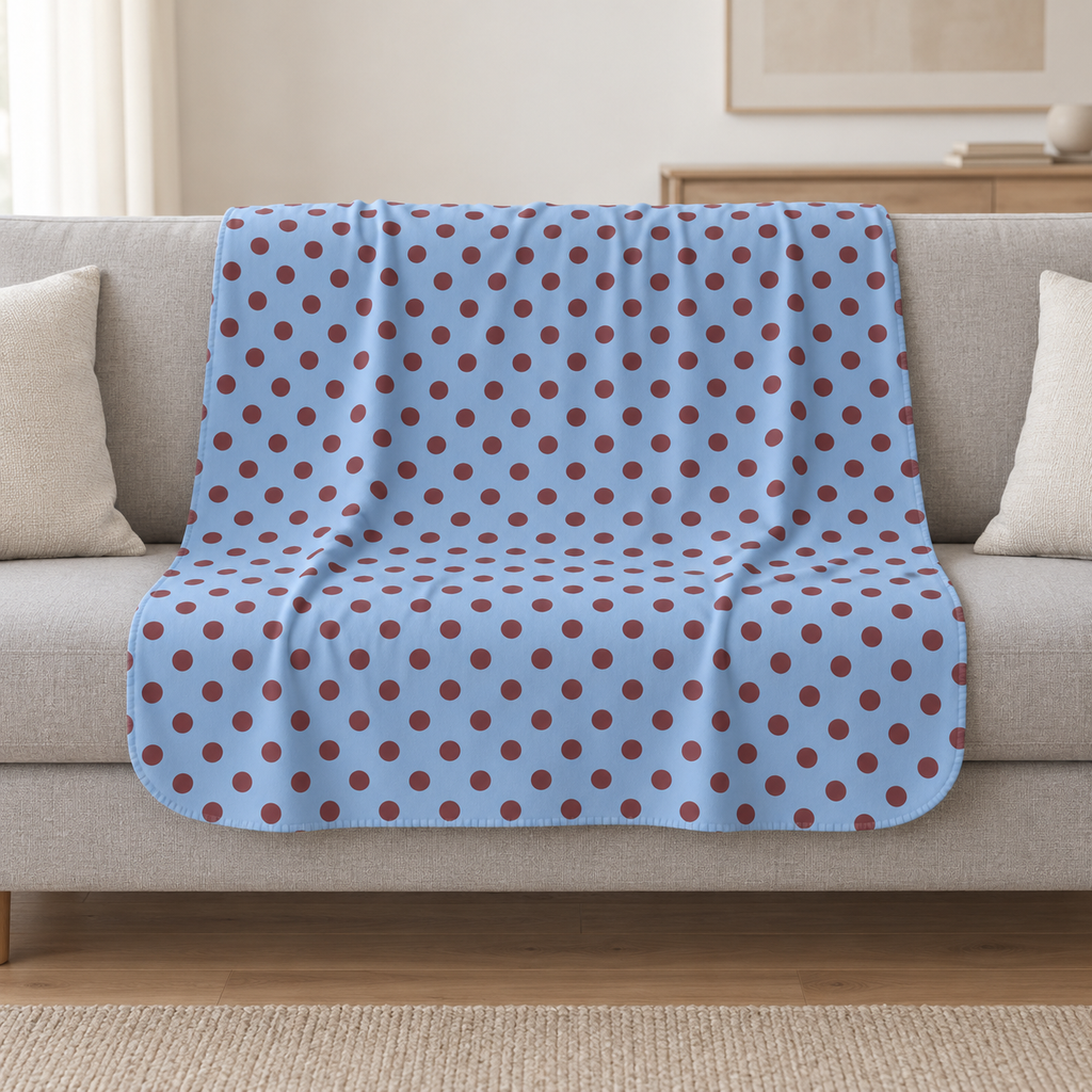 Blue Polka Dot Sherpa Blanket draped over a cream sofa in a living room