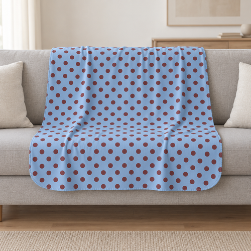 Blue Polka Dot Sherpa Blanket draped over a cream sofa in a living room