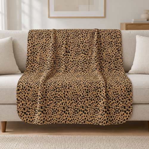 Brown Cheetah Print Sherpa Blanket draped over a cream sofa in a living room