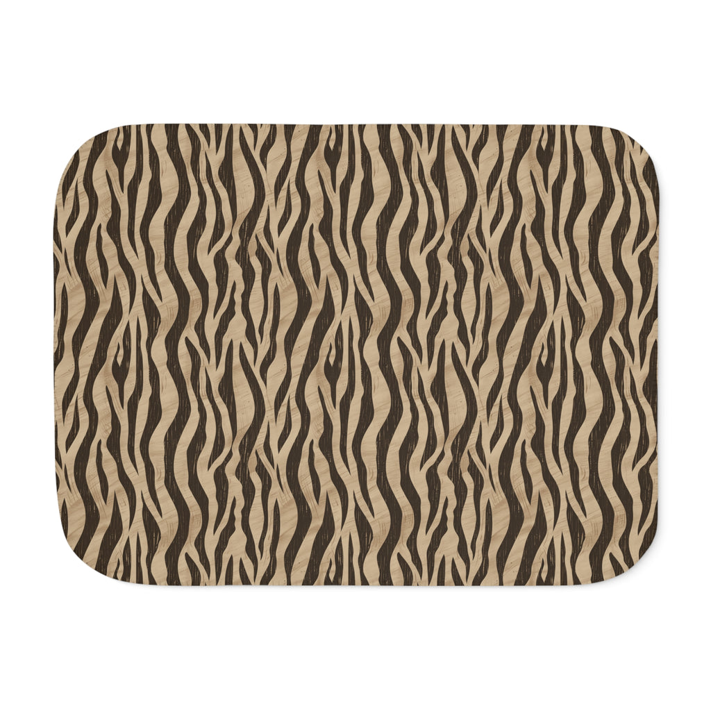 Brown tiger stripe sherpa blanket laid flat, showing deep brown stripes on a sand ground with a white sherpa edge
