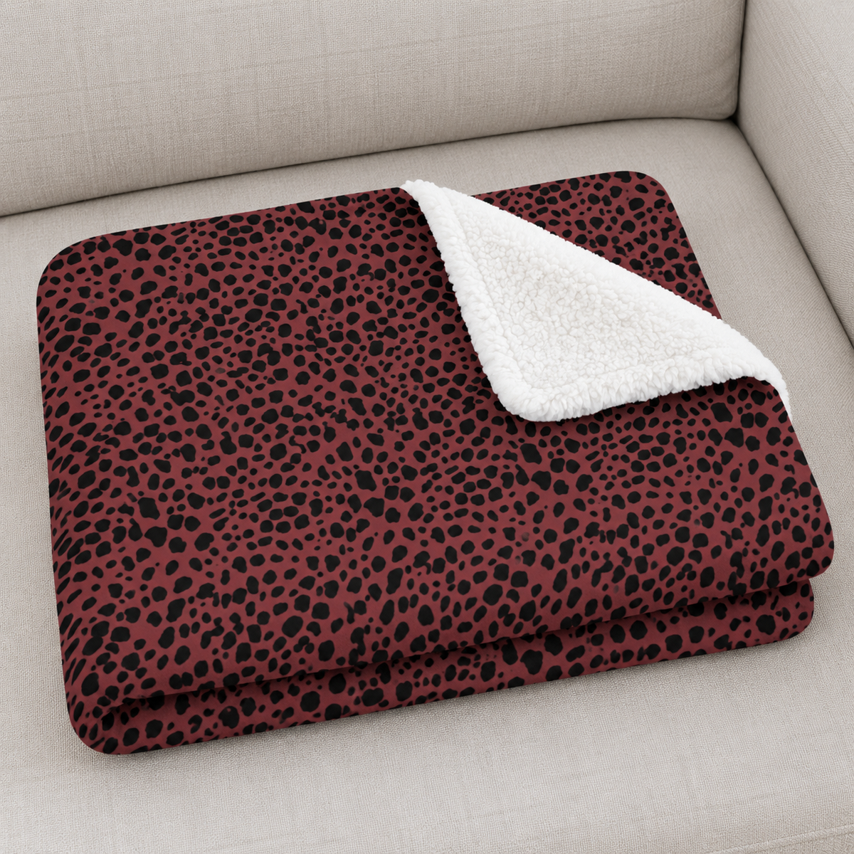 Close-up of the folded Burgundy Cheetah Print Sherpa Blanket showing the sherpa back