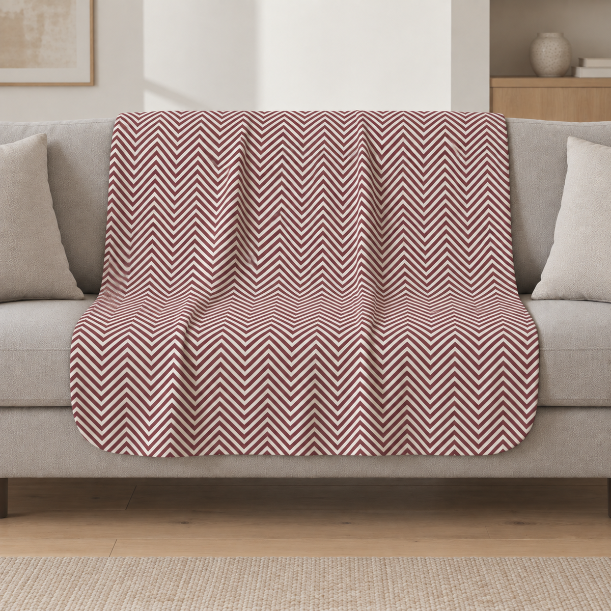 Burgundy Herringbone Sherpa Blanket draped over a cream sofa in a living room