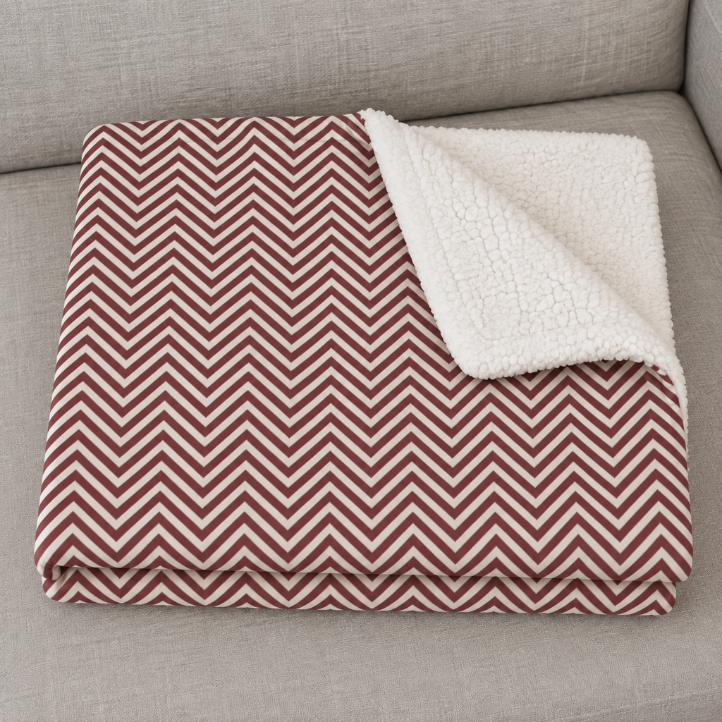 Close-up of the folded Burgundy Herringbone Sherpa Blanket showing the sherpa back