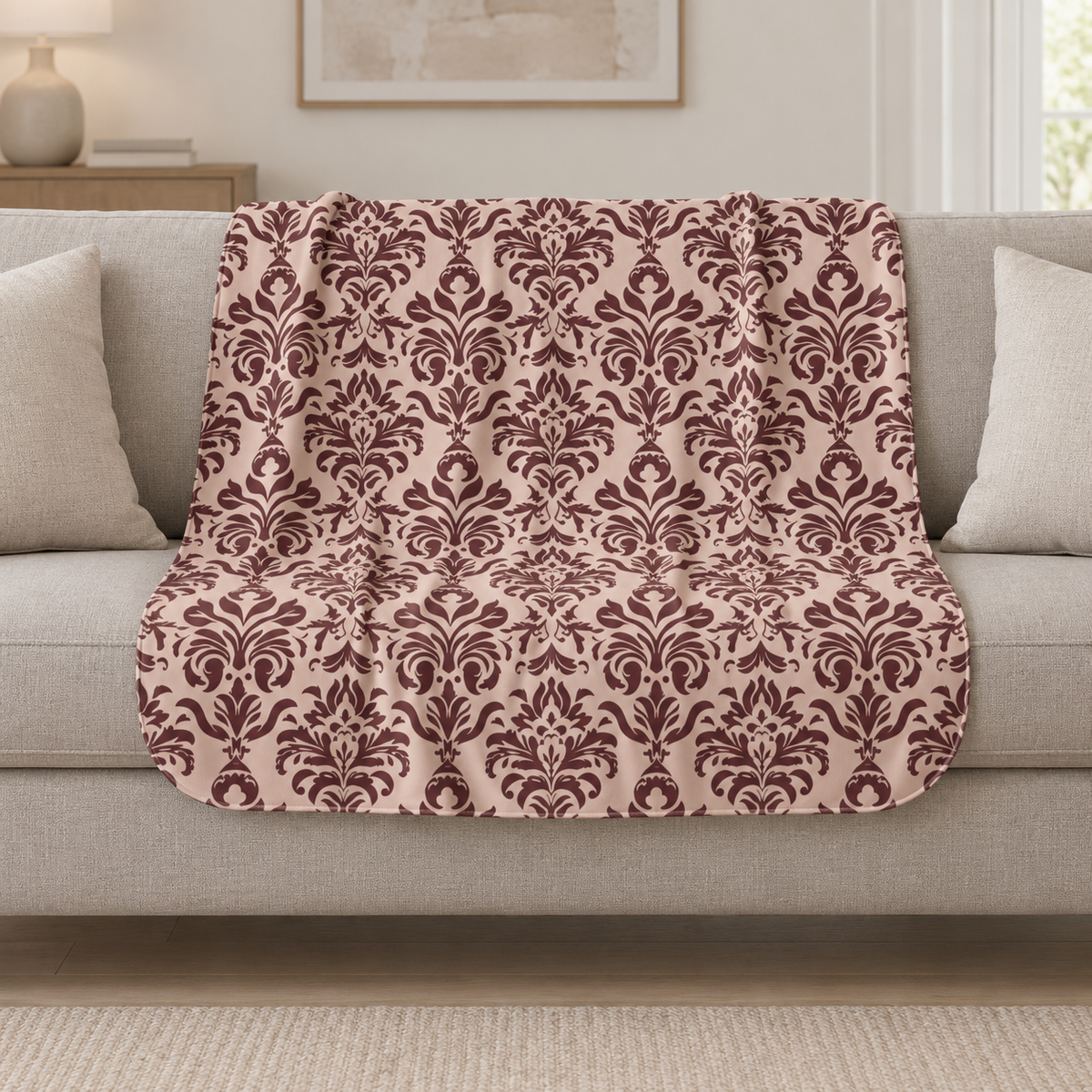 Burgundy Tapestry Sherpa Blanket draped over a cream sofa in a living room