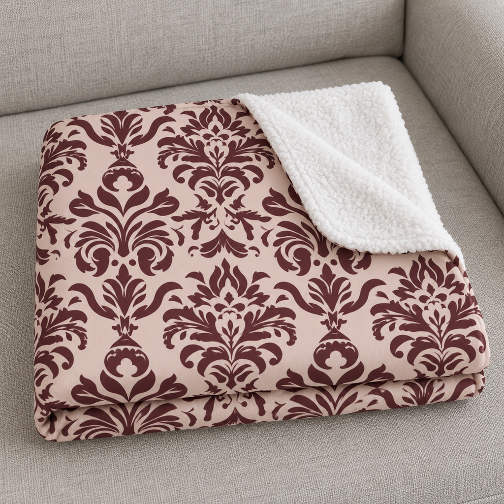 Close-up of the folded Burgundy Tapestry Sherpa Blanket showing the sherpa back