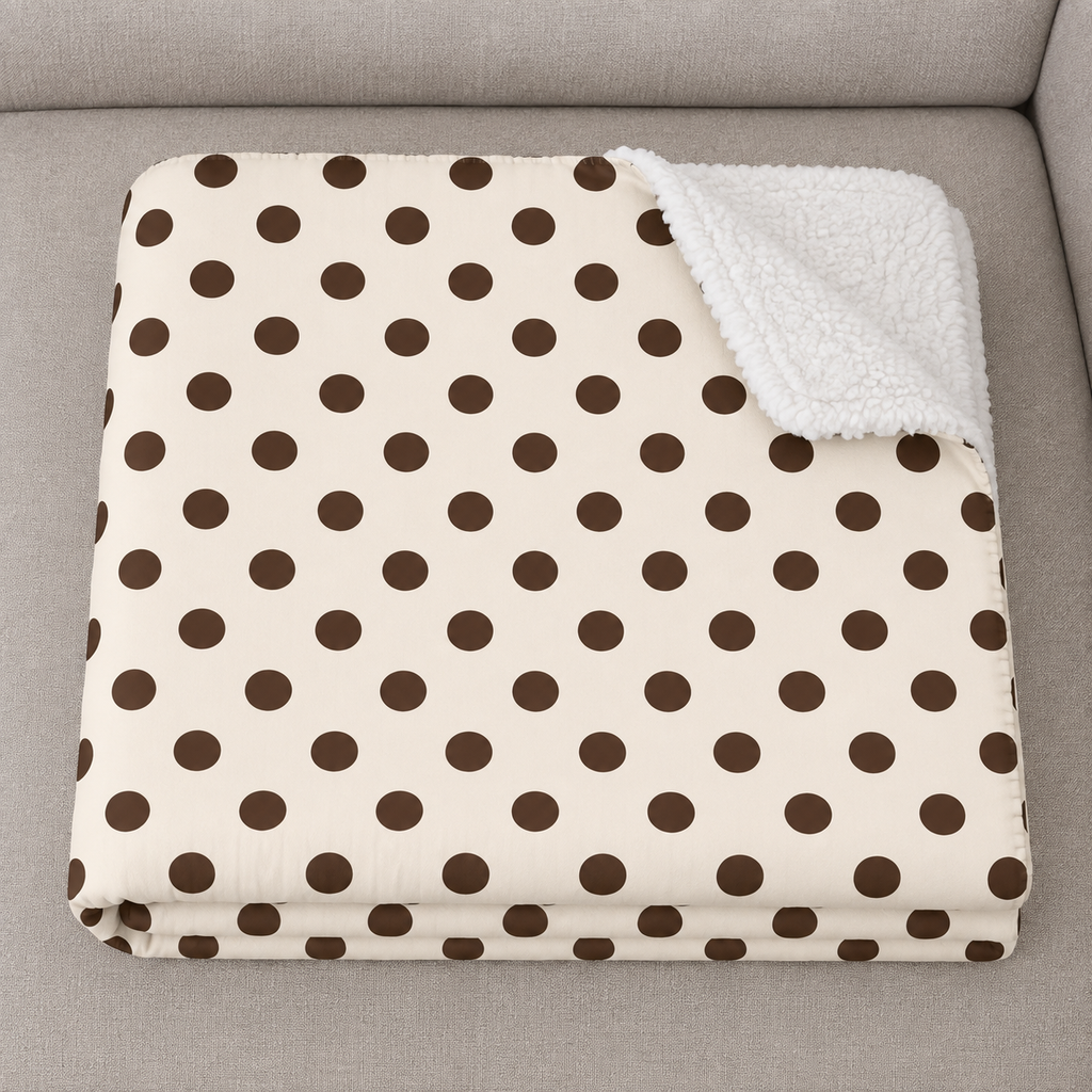 Close-up of the folded Cream Polka Dot Sherpa Blanket showing the sherpa back