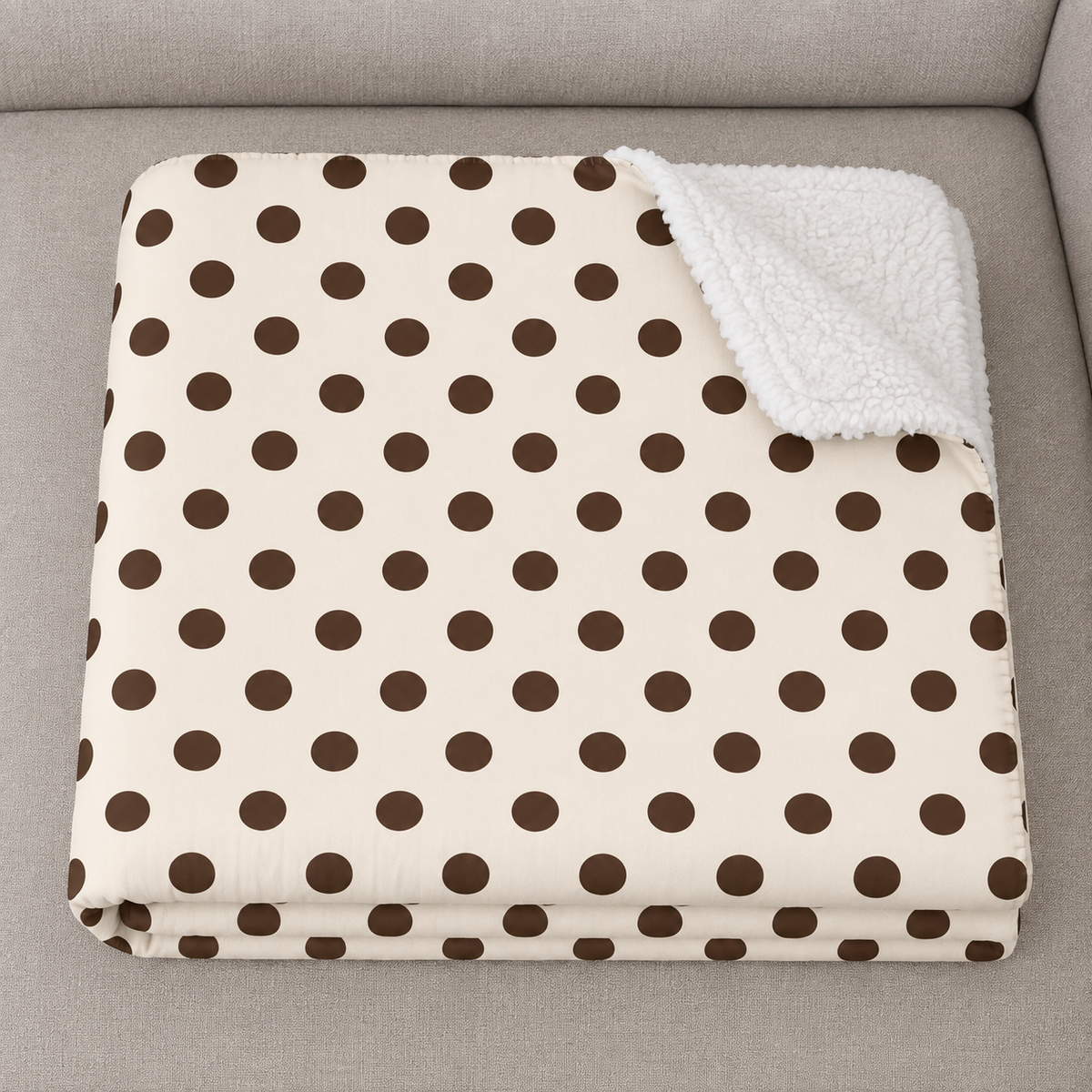 Close-up of the folded Cream Polka Dot Sherpa Blanket showing the sherpa back