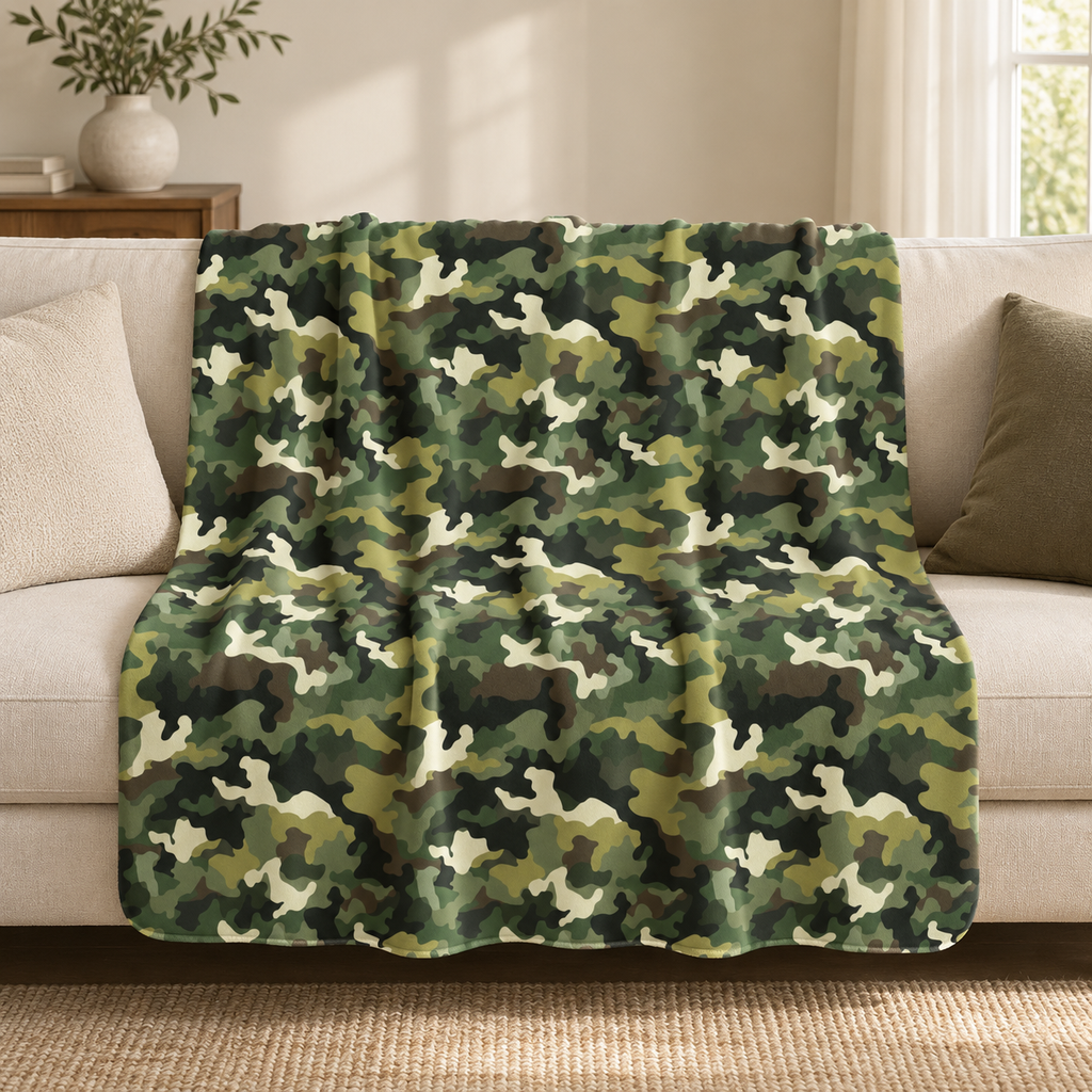 Green camo sherpa blanket draped over a couch as a camouflage throw