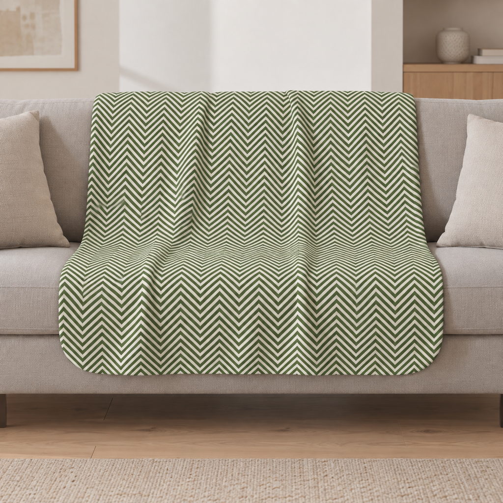 Green Herringbone Sherpa Blanket draped over a cream sofa in a living room