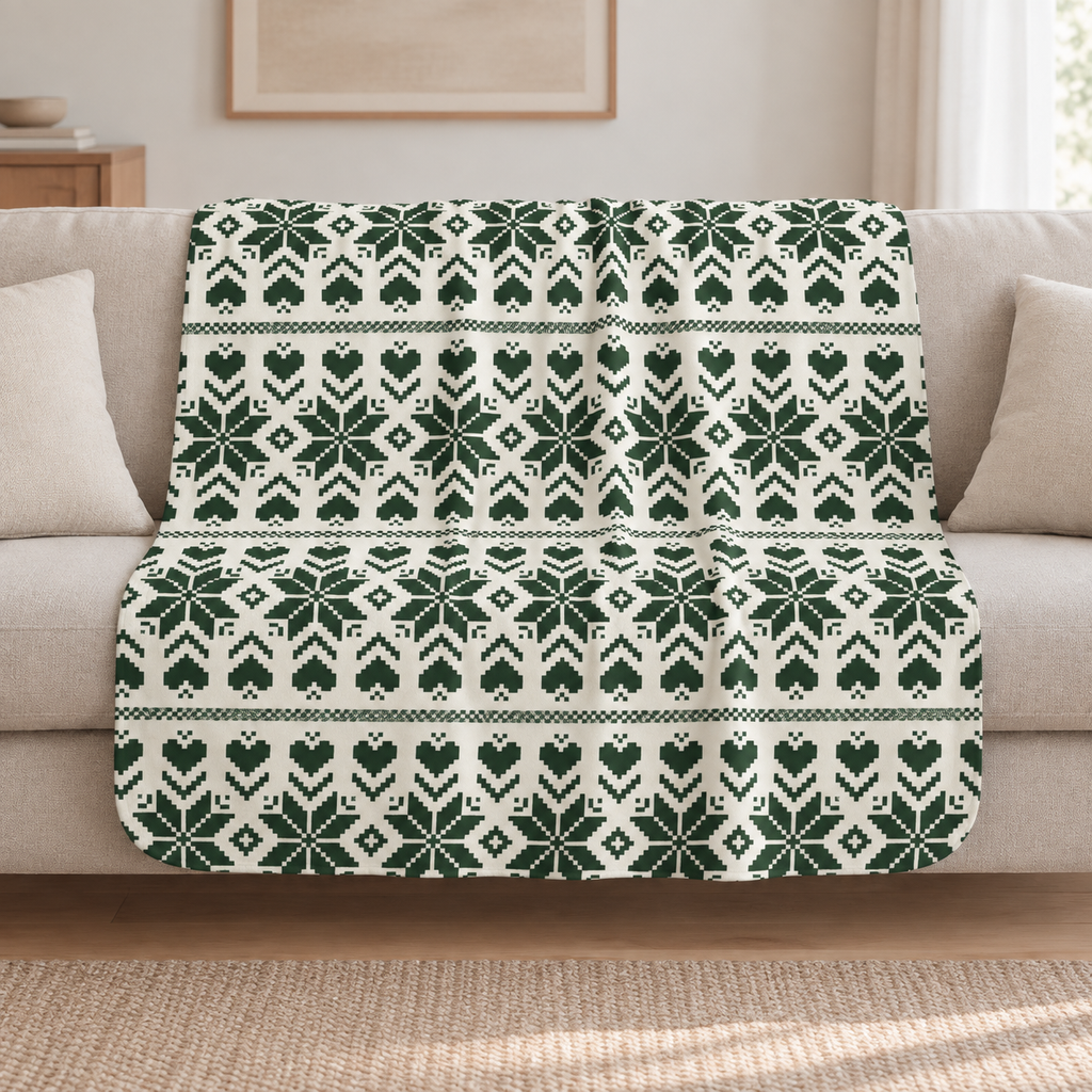 Green Nordic Star Christmas Sherpa Blanket draped over a cream sofa in a living room