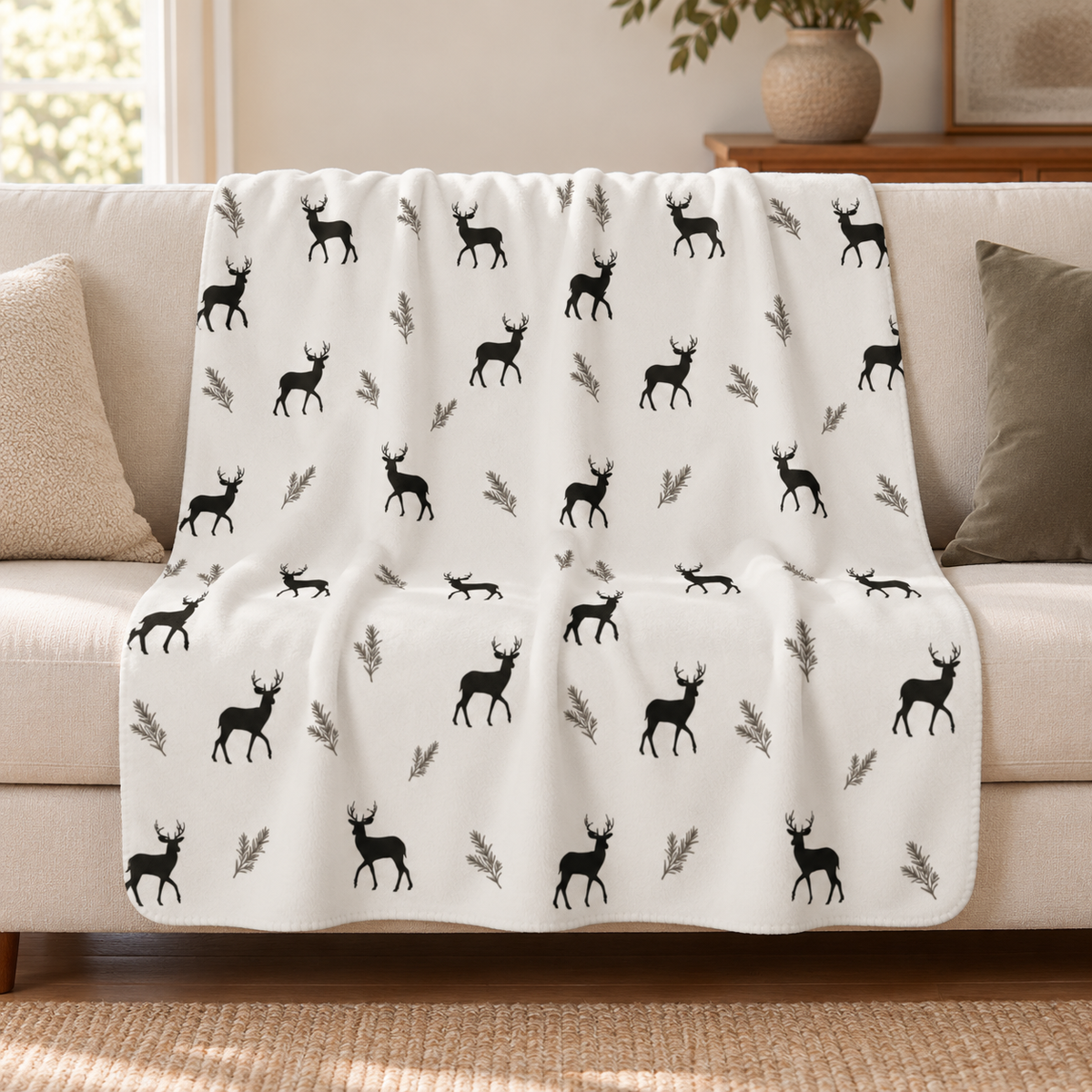Grey deer print sherpa blanket draped over a cream sofa in a living room
