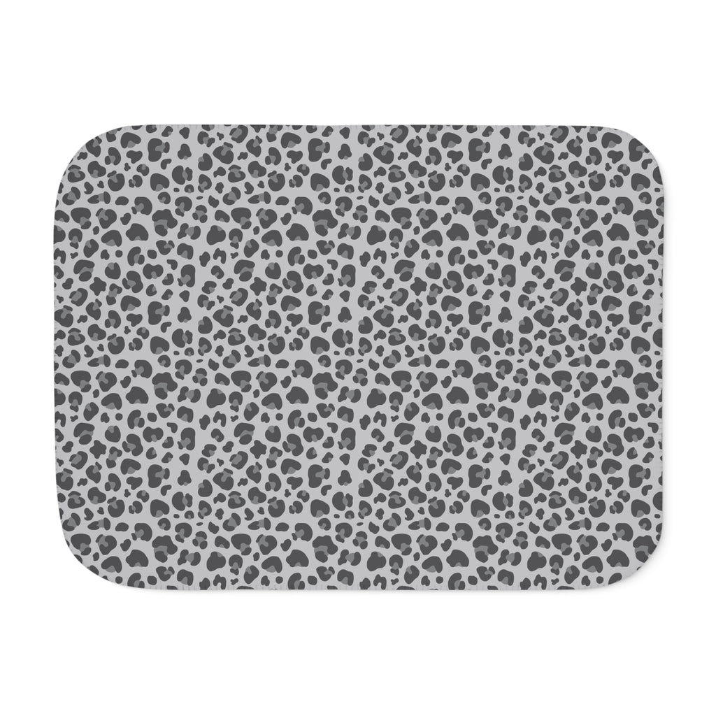 Grey leopard print sherpa blanket laid flat, showing open soft grey, charcoal and cream rosettes with a white sherpa edge