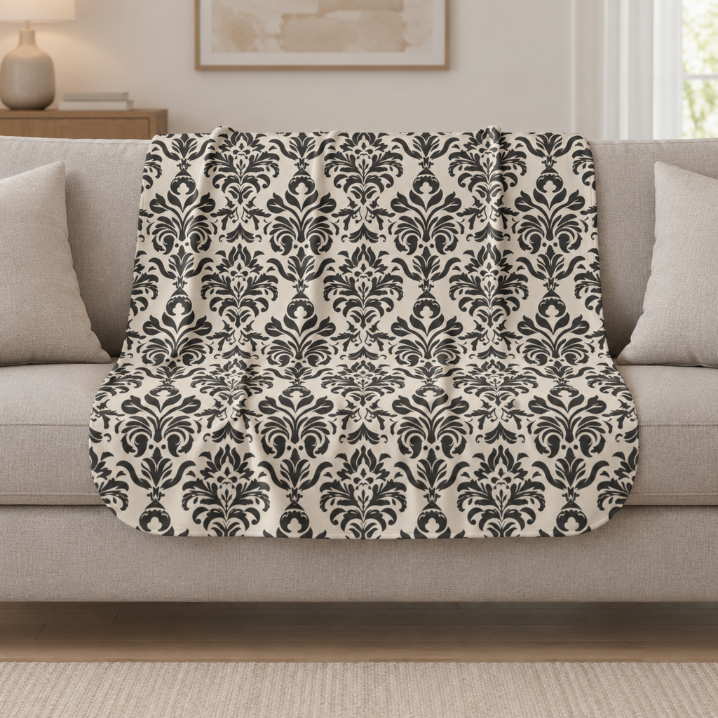 Grey Tapestry Sherpa Blanket draped over a cream sofa in a living room