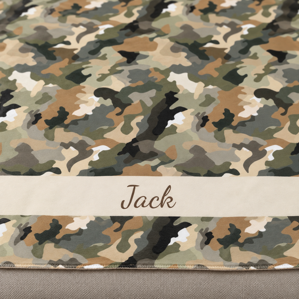 Personalized brown camo sherpa blanket with name, close-up of the name in script on the band