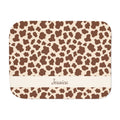 Personalized brown cow print sherpa blanket with name, front view with name band