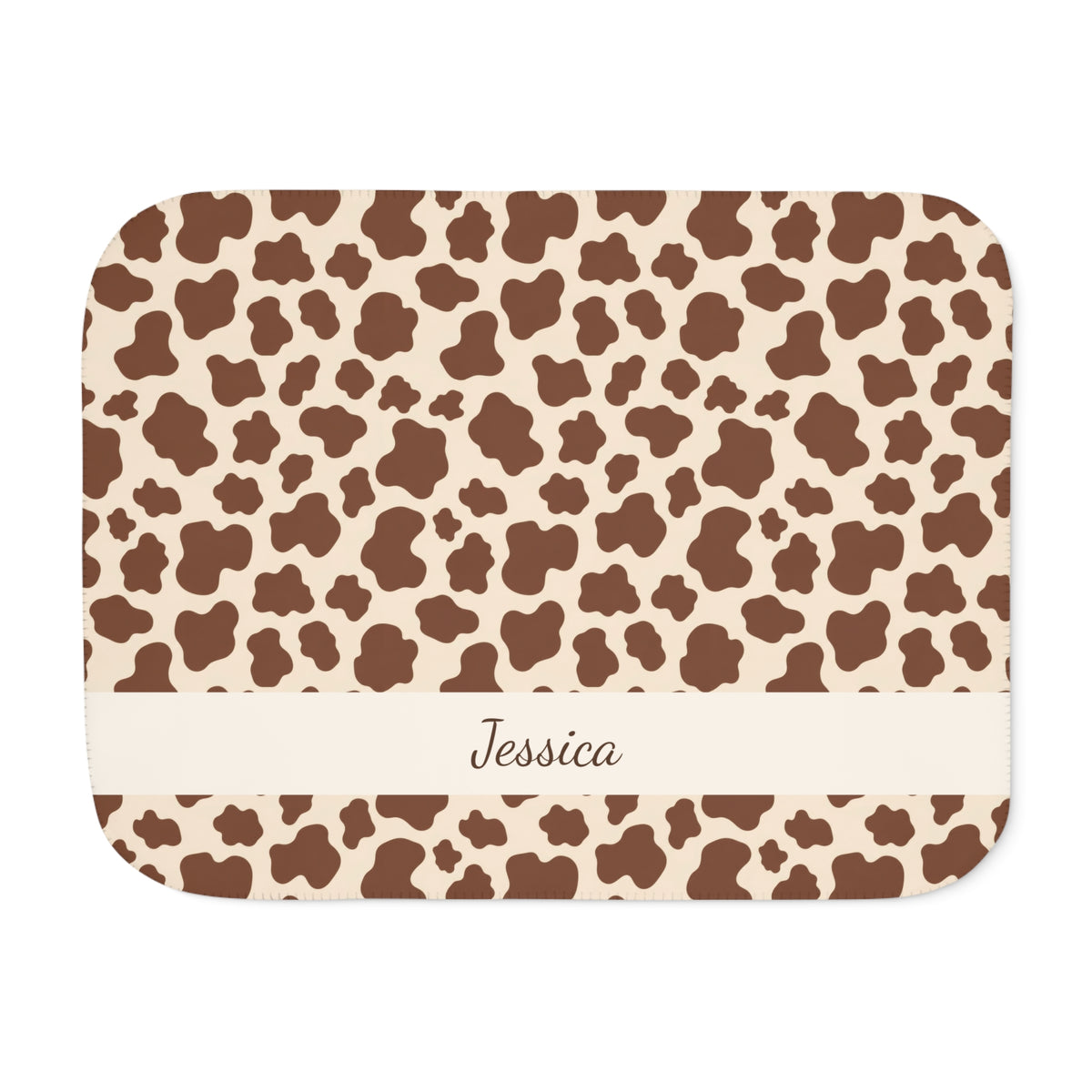 Personalized brown cow print sherpa blanket with name, front view with name band