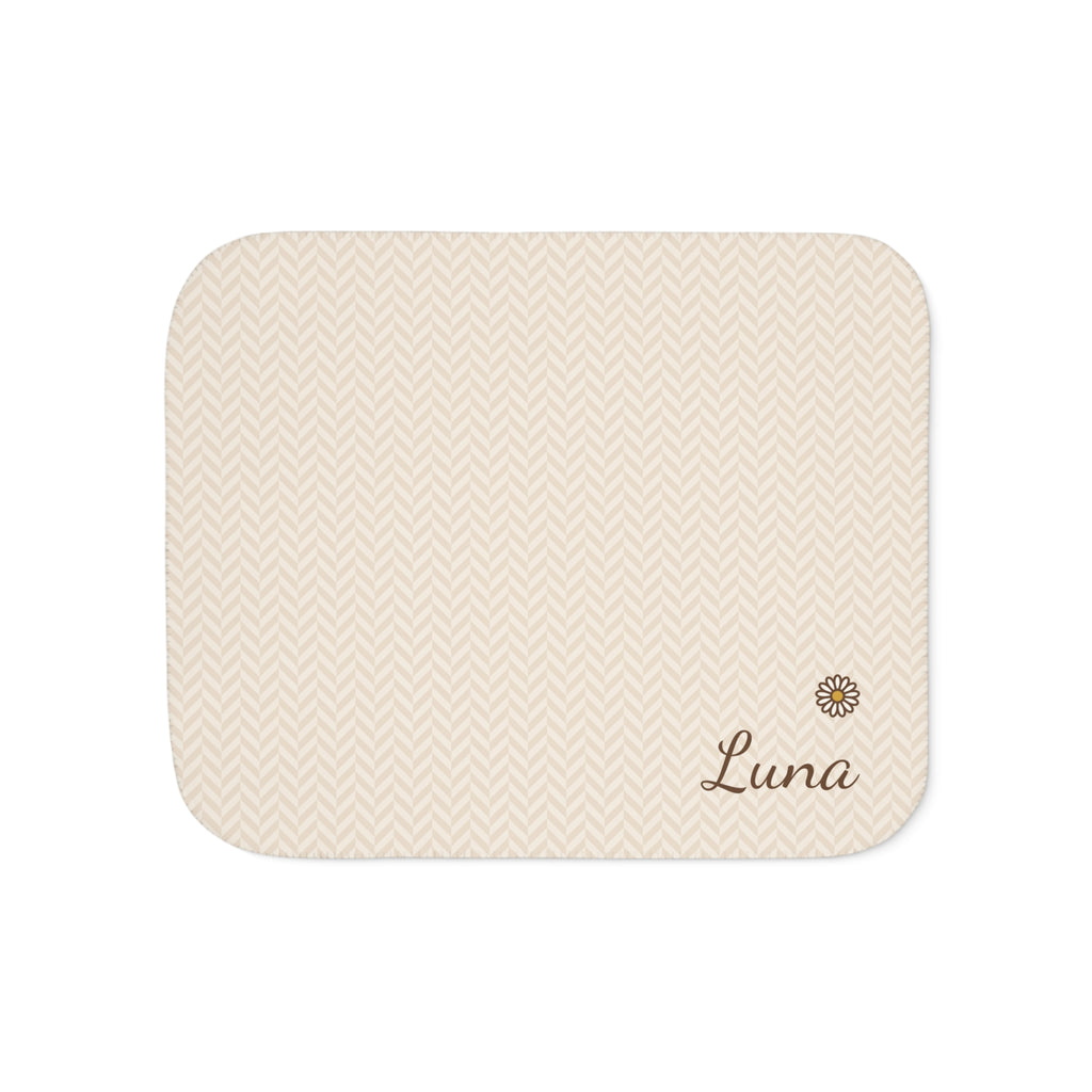 Personalized cream baby blanket with name and a flower, front view with name and flower