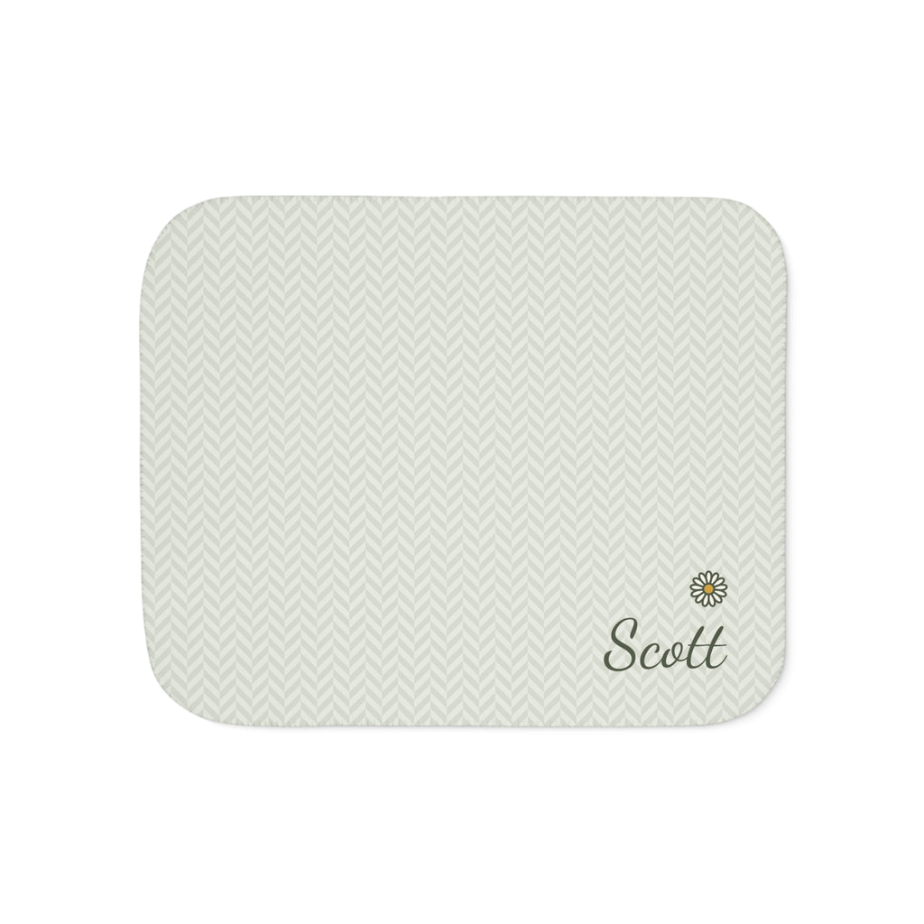 Personalized green baby blanket with name and a flower, front view with name and flower