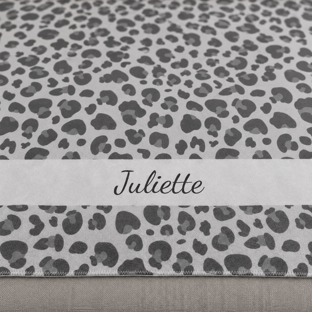 Personalized grey leopard print sherpa blanket with name, close-up of the name in script on the band