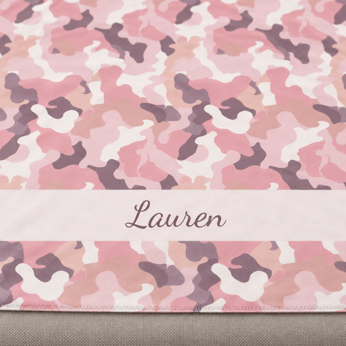 Personalized pink camo sherpa blanket with name, close-up of the name in script on the band