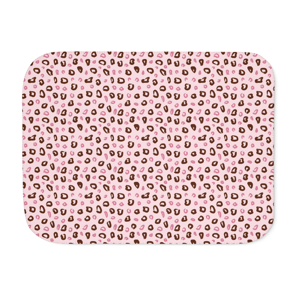 Pink leopard print sherpa blanket laid flat, showing open blush and dusty rose rosettes with a white sherpa edge