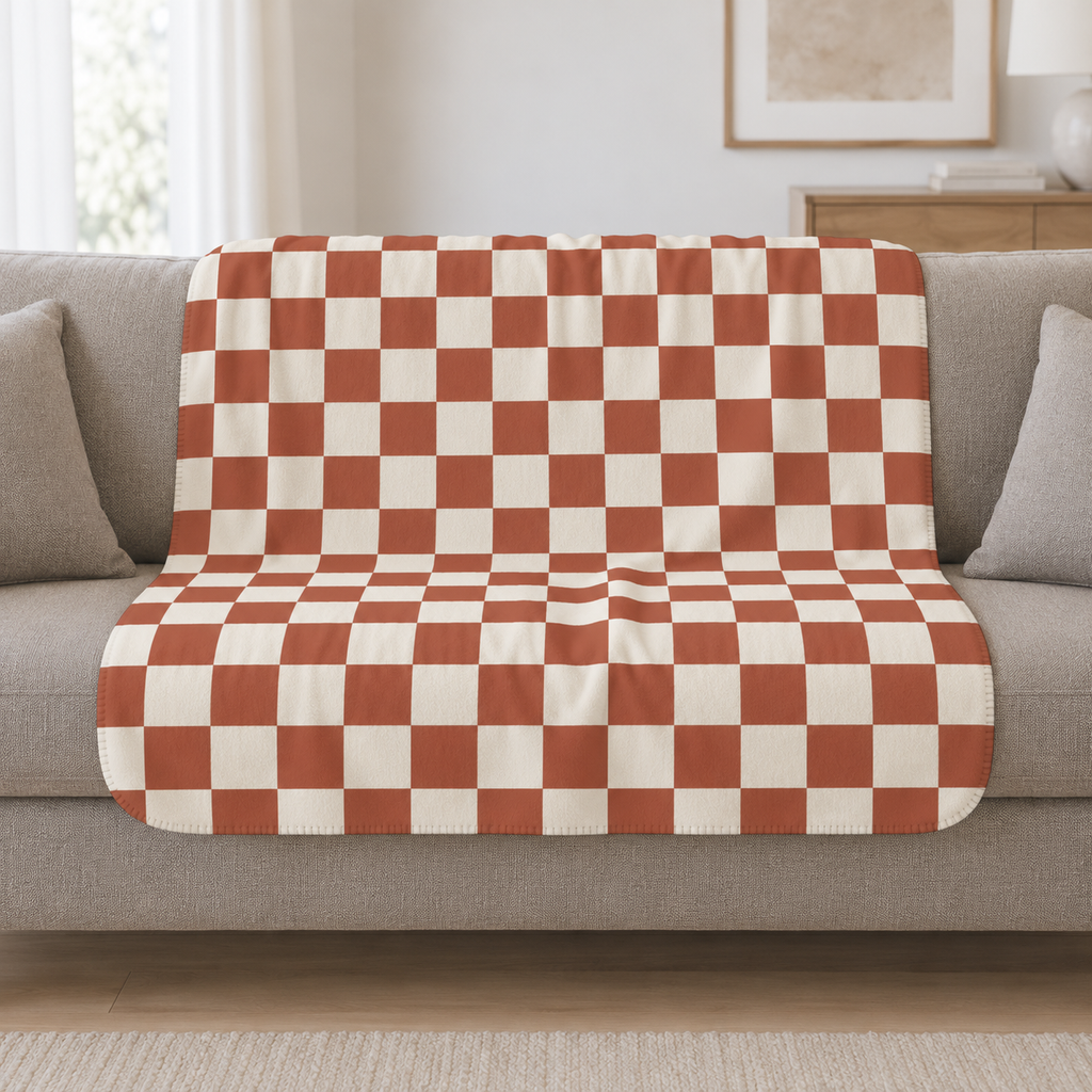 Terracotta Checkered Sherpa Blanket draped over a cream sofa in a living room